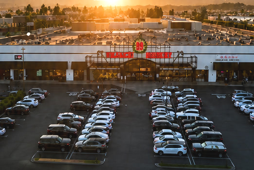 99 Ranch Market shopping center and parking lot at sunset in Rowland Heights